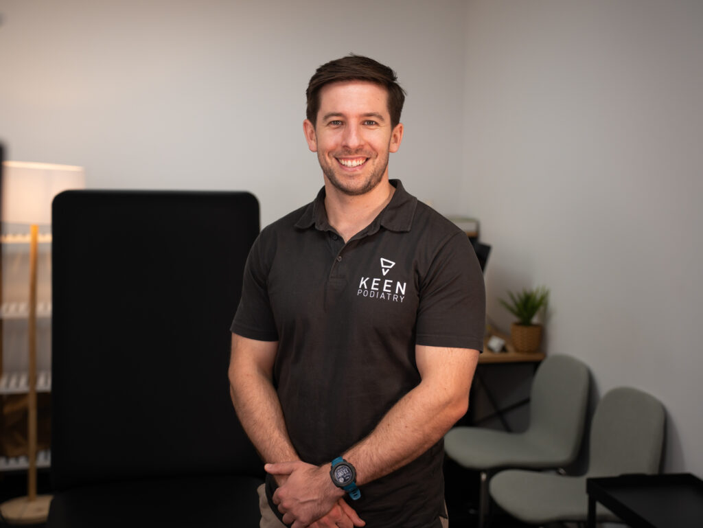 Headshot of Podiatrist Matt in his treatment room at Keen Podiatry.